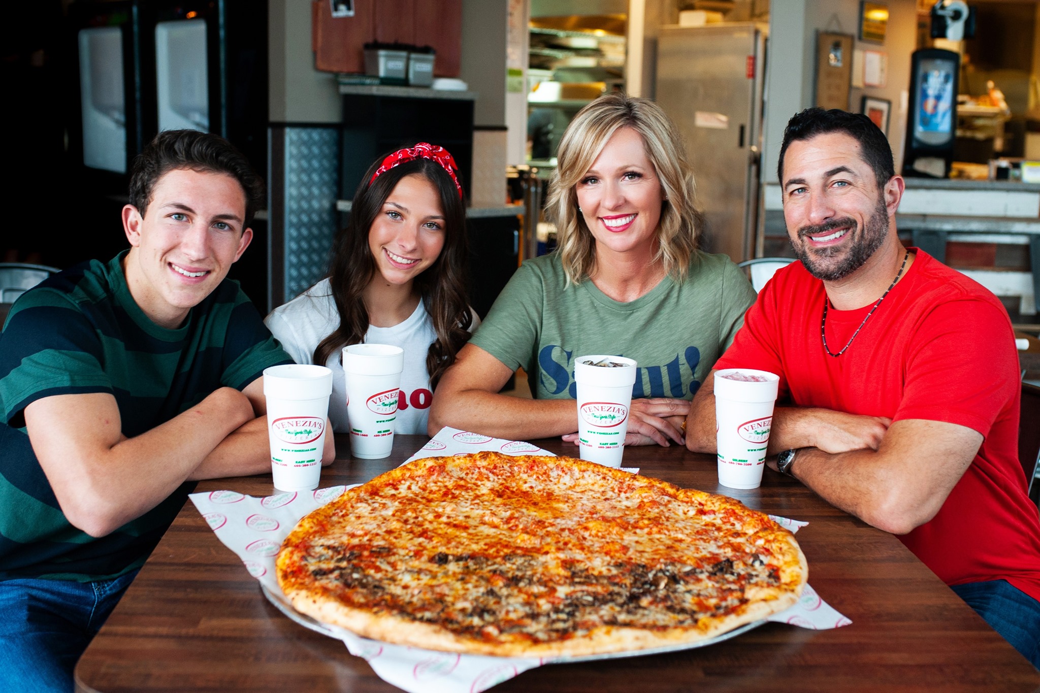 Venezia's Pizzeria owner Domenick sitting at a table with his family