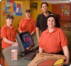 Rascal House Pizza employees around their POS